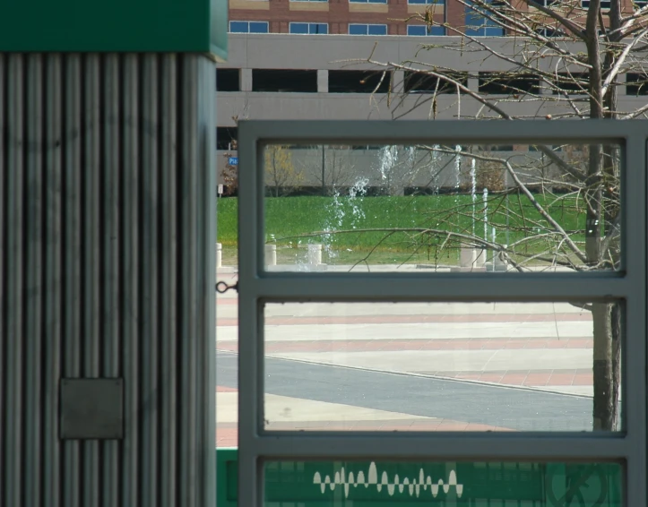 the window in the building shows the park