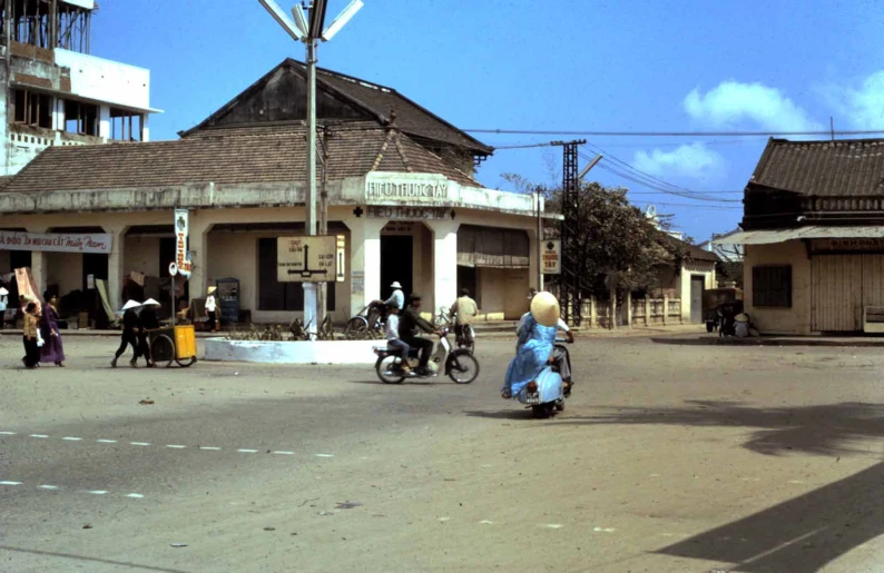 a lady is walking through a street that has old buildings