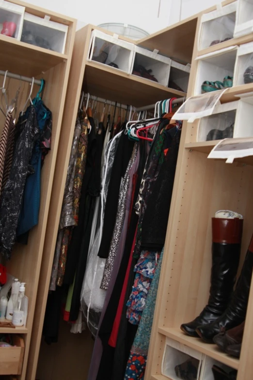 the closet is full of various items such as clothes