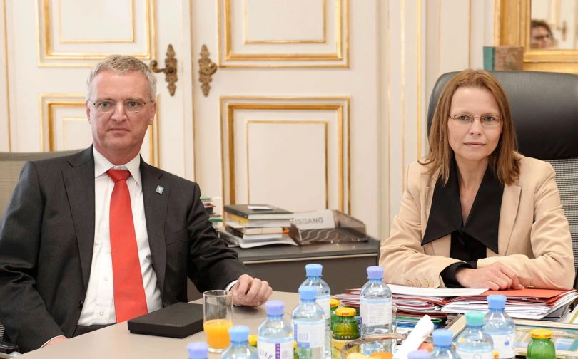 two people sitting at a table with drinks