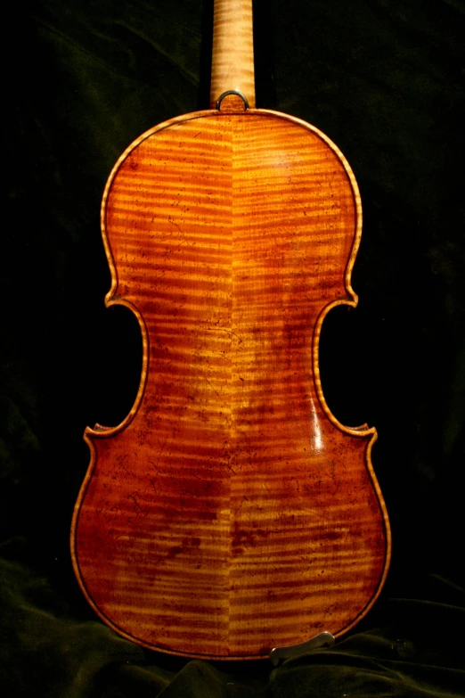 an antique violin with wooden body and wood trimmings