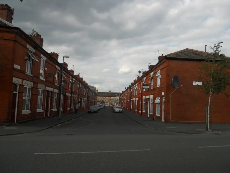 the street in front of the brick buildings is empty