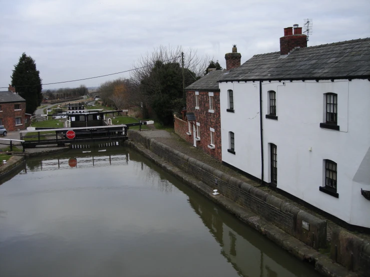 houseboat passing through narrow canal in rural countryside