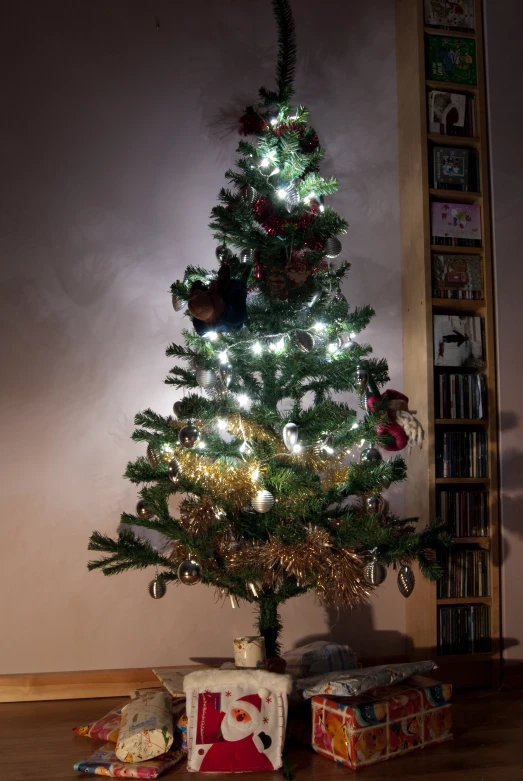 small green and red christmas tree with presents under