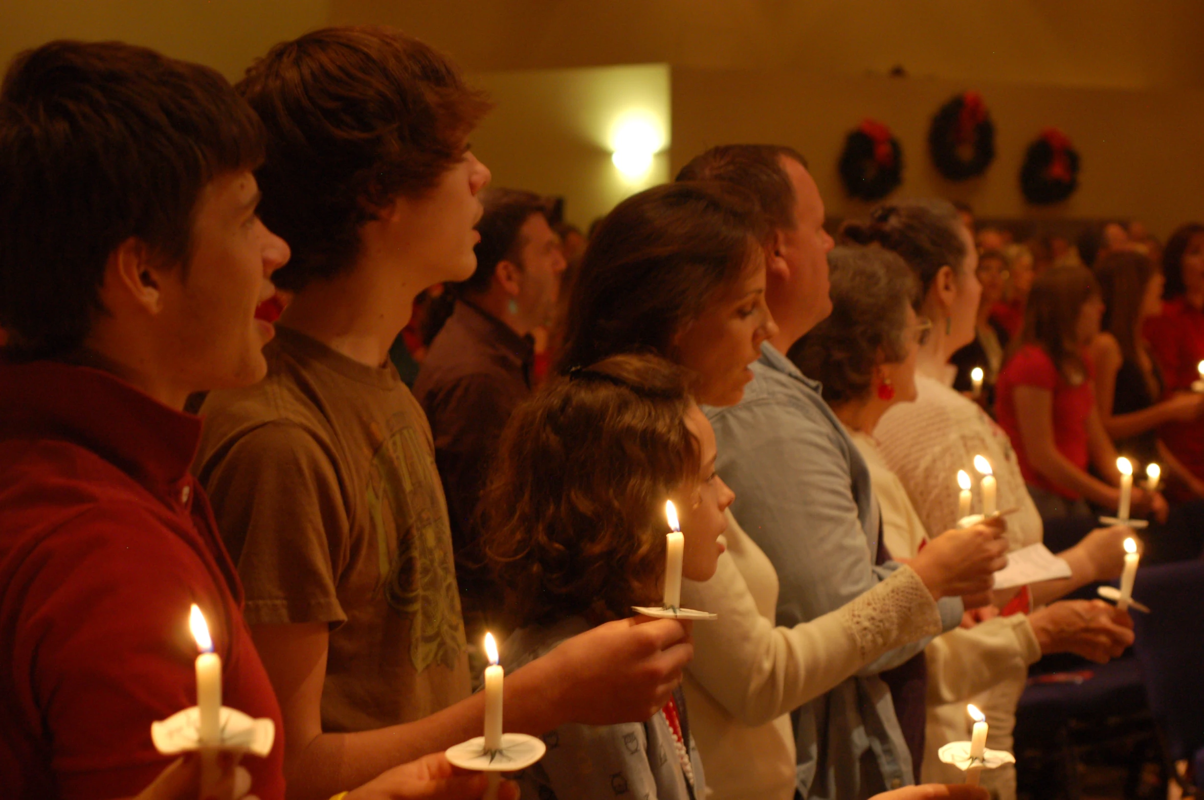 children in a church with many lit candles