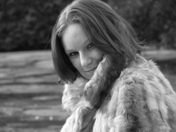 black and white pograph of a woman wearing a furry coat