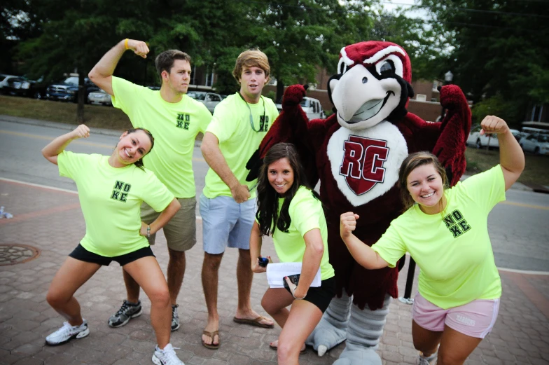 a group of students posing with a mascot