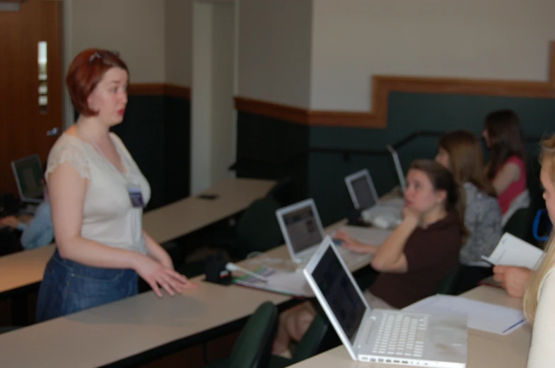 a woman is presenting soing on her laptop