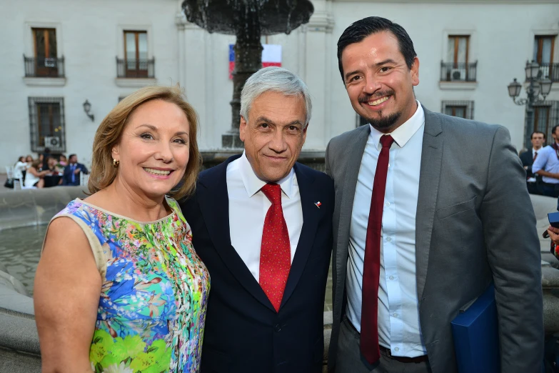 two men and one woman pose together for a po