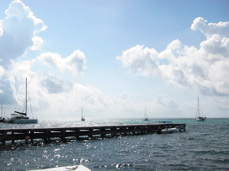 the sail boats are docked near the pier