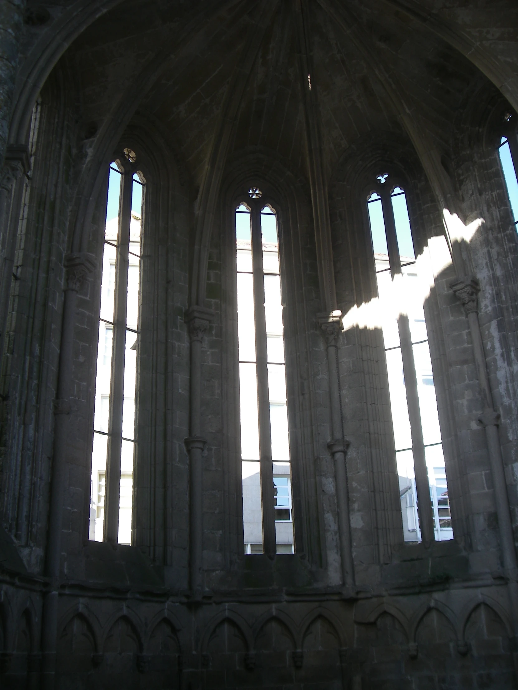 the sun is shining through three gothic windows