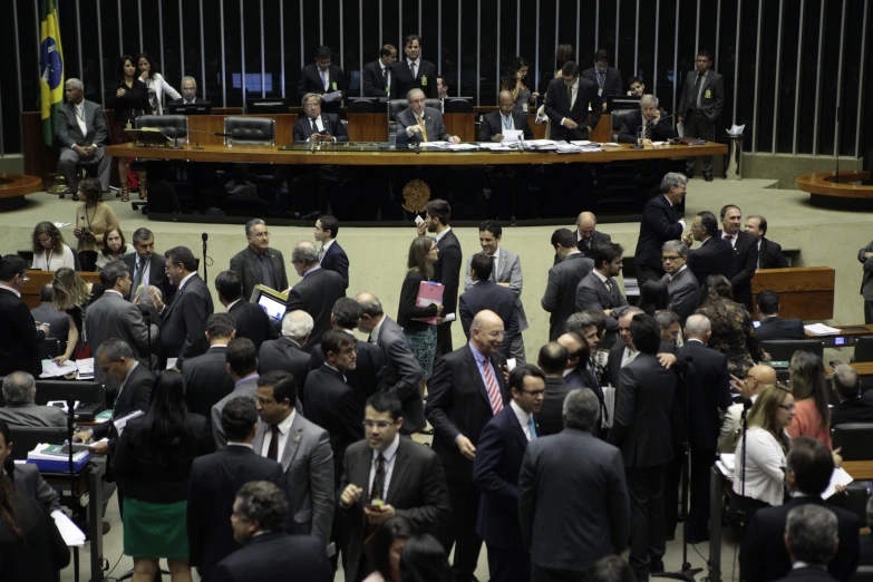 a crowd of people are walking in a room