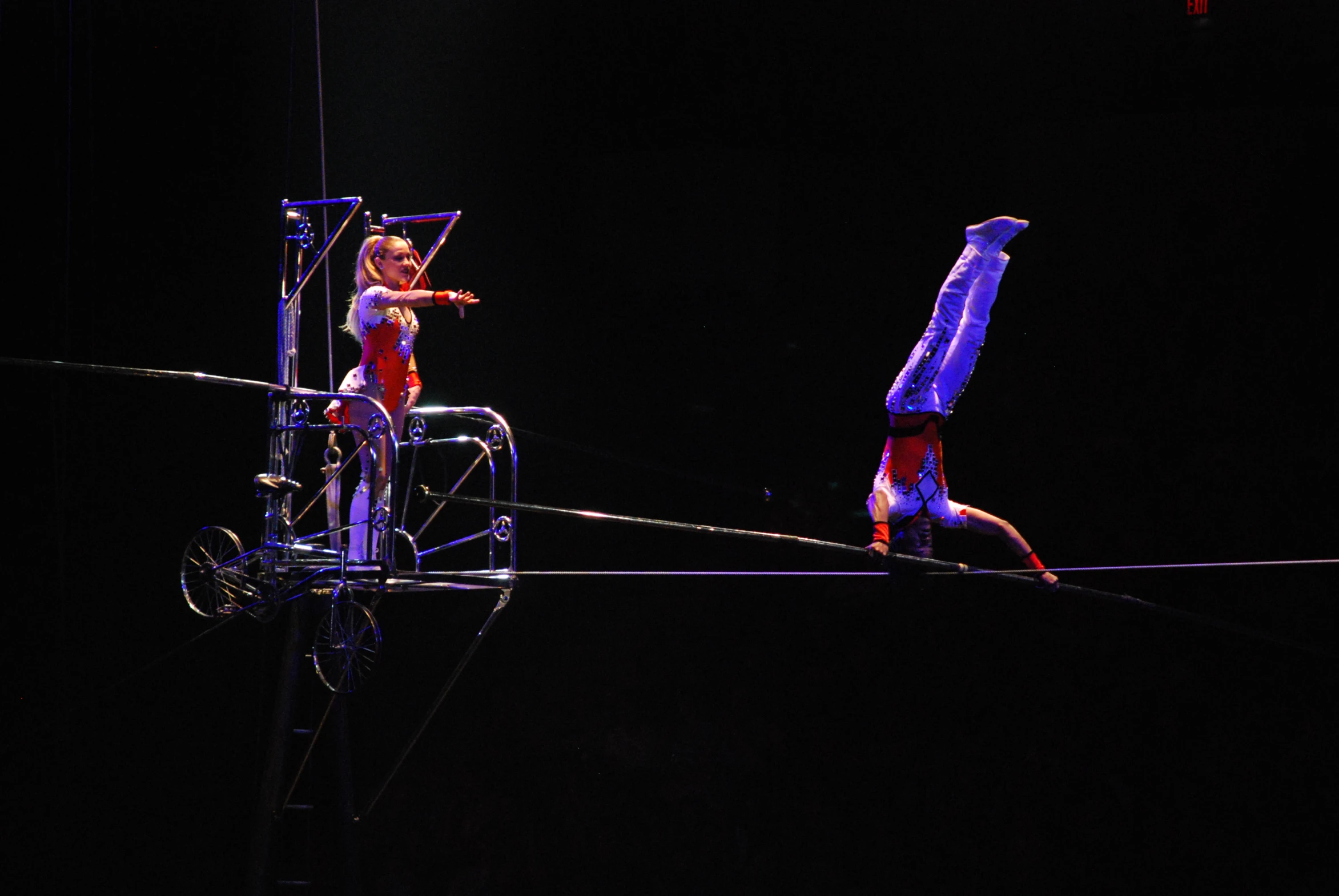 people on a rope during a performance at night