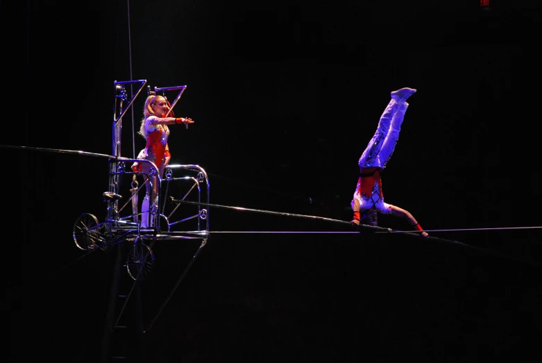 people on a rope during a performance at night