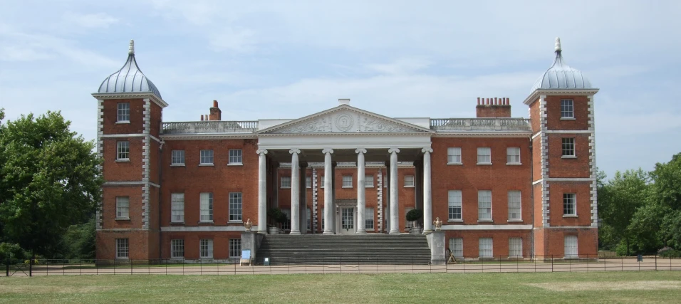 a large brick building with multiple columns and many windows