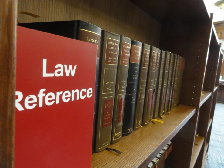 law reference books sit next to each other on a book shelf