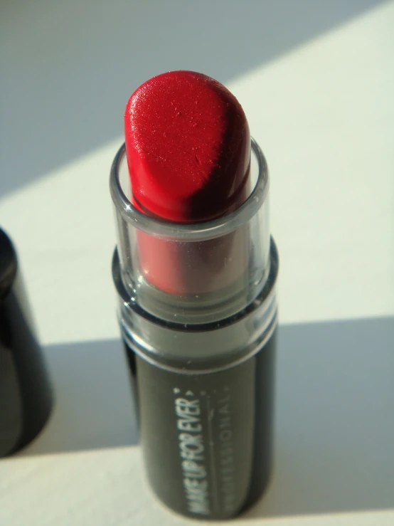 the base of a lipstick with the top partially open