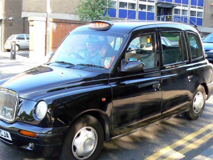 a black cab that is on the street