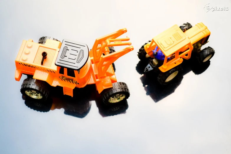 two toy trucks made out of lego parts