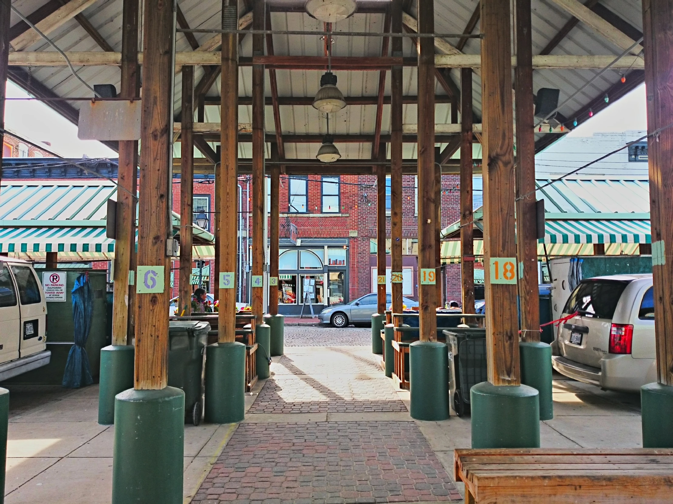 several wooden benches and tables in front of buildings