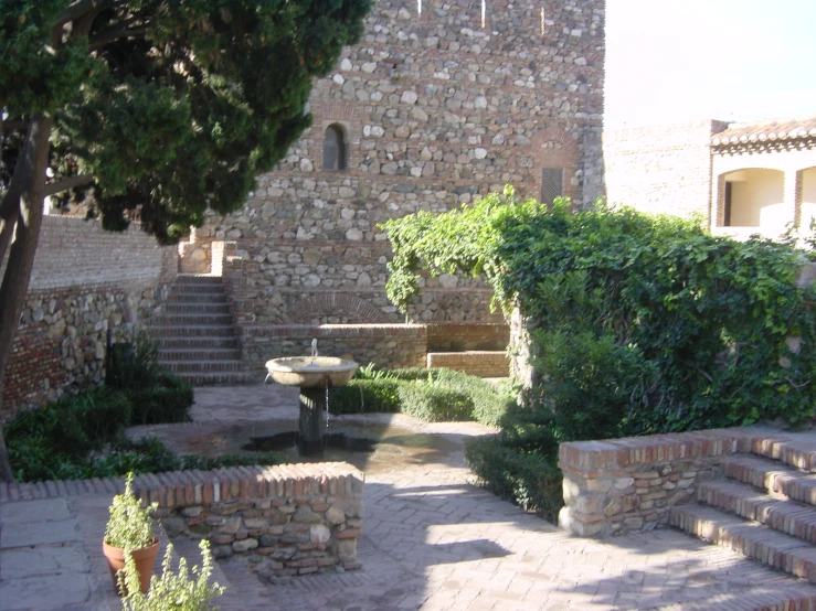 an outdoor area with stone walls and steps