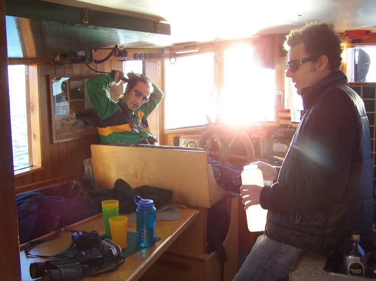 the man is standing at the table with some drinks