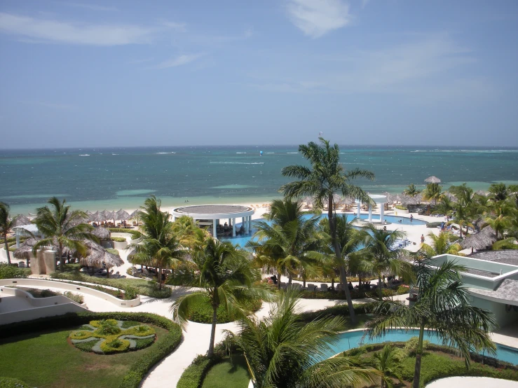 a resort overlooks the ocean and pool on the island