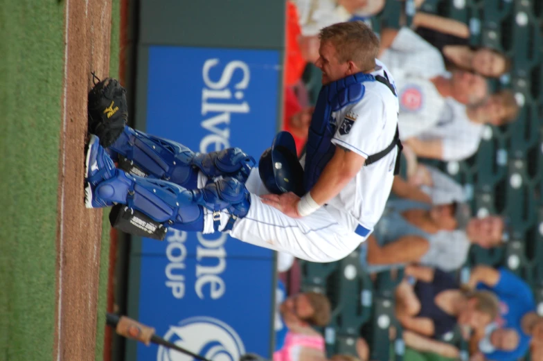 there is a catcher that is looking down on home plate