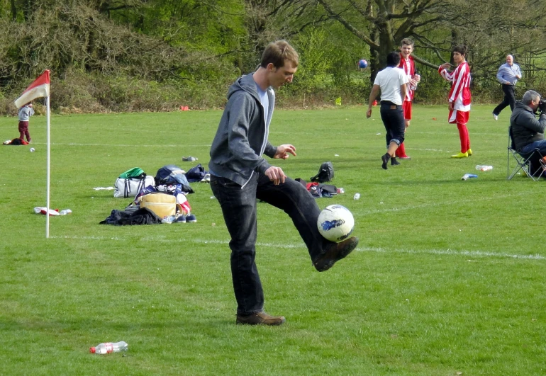 a man is kicking a soccer ball during a practice session