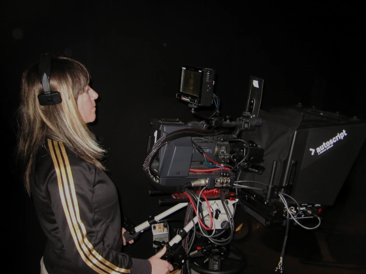 a woman standing next to a camera set