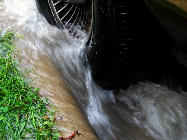 a very big stream of water running down a road