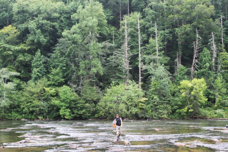 a man is standing in some very small stream