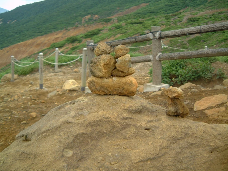 there are two rocks and one rock on the ground