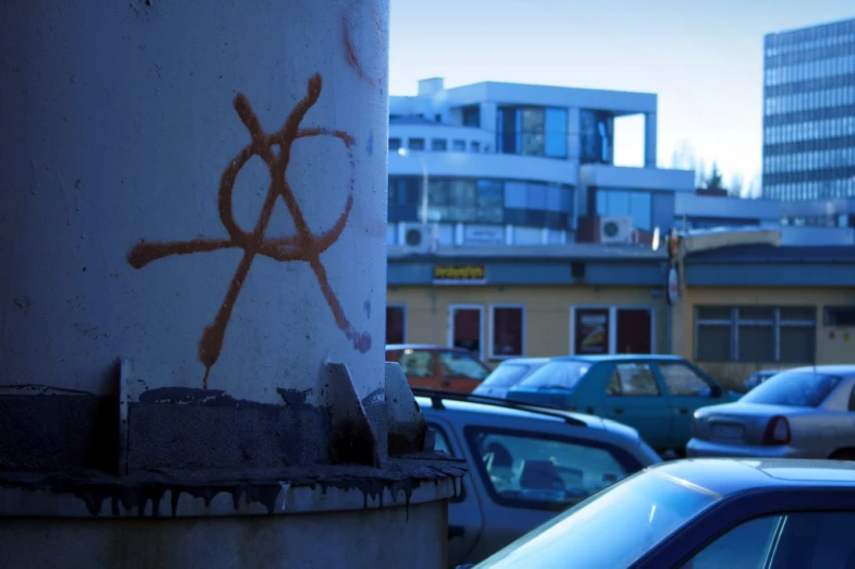 graffiti painted on a concrete column with a city in the background