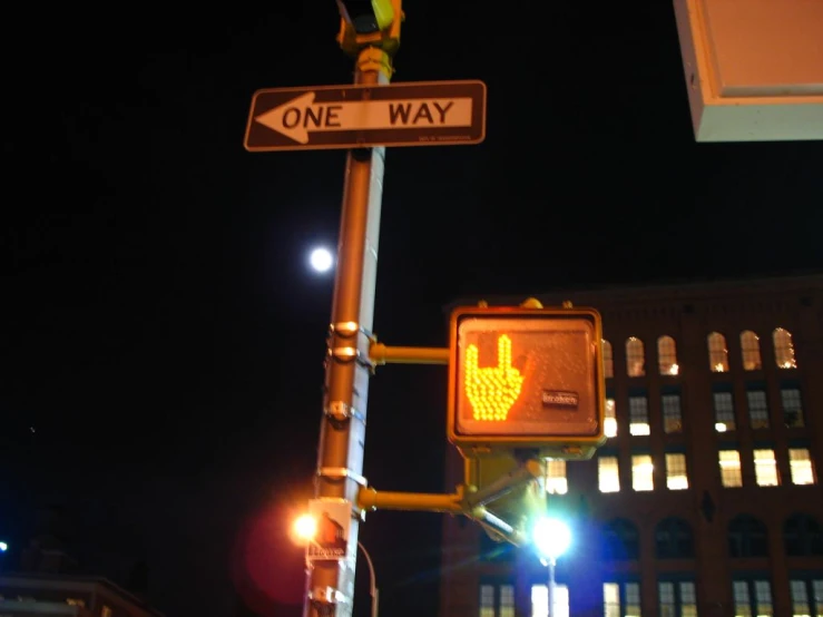 a sign on a street light at a cross walk