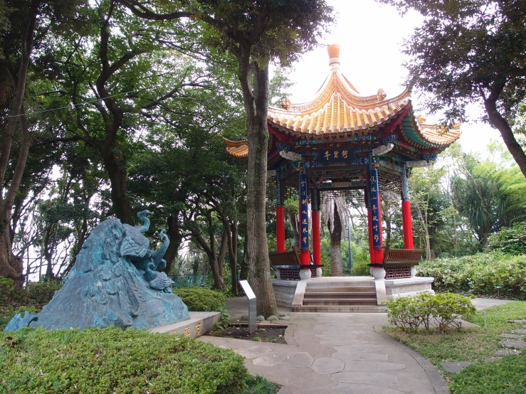 a small pavilion with a red ribbon hanging off of it