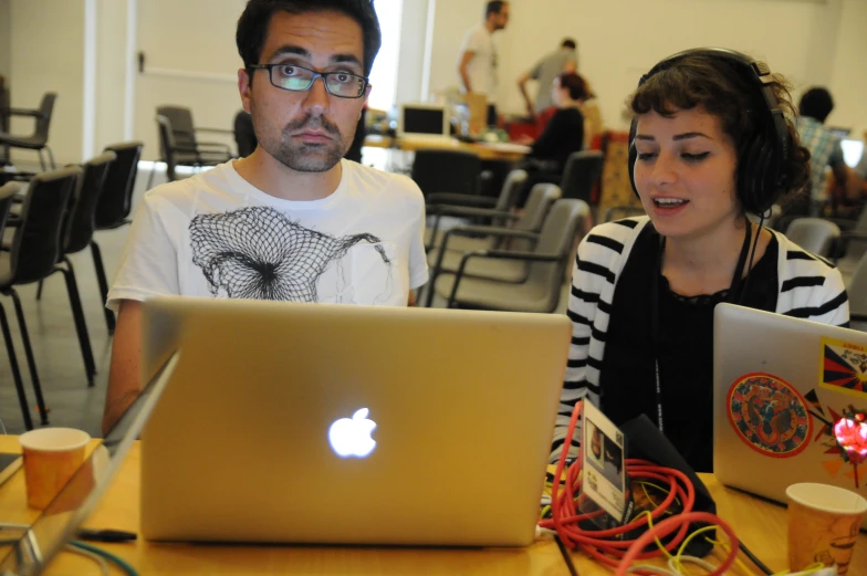 an old man and woman at a laptop computer