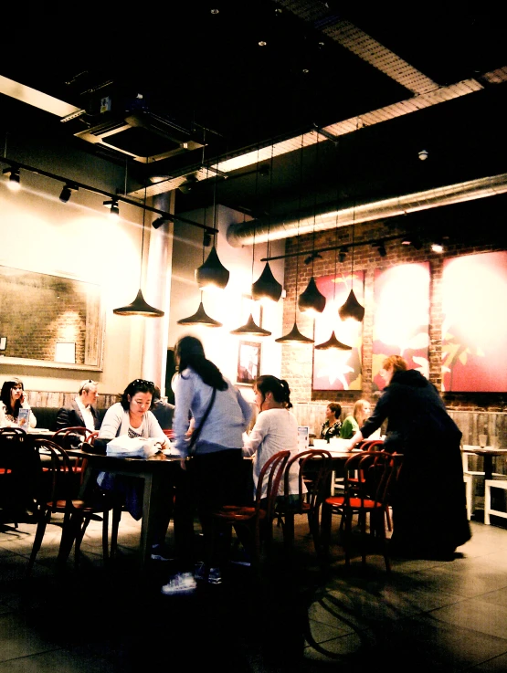 some people sitting around a table with food