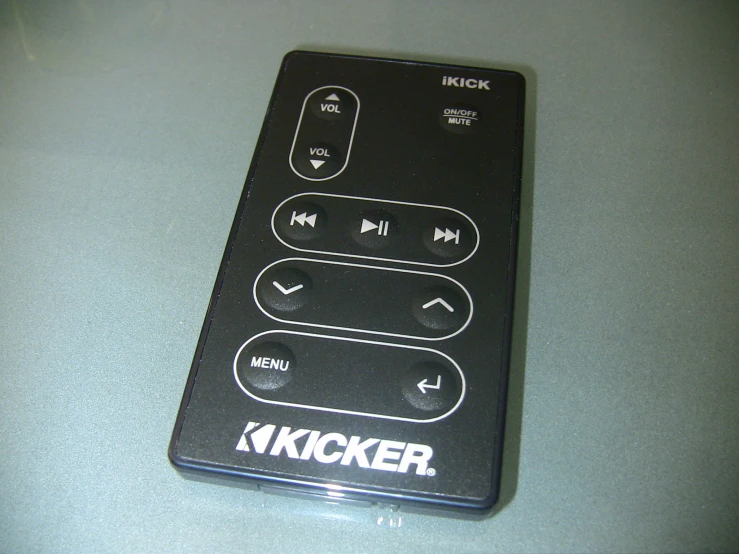 a remote control sitting on a grey surface