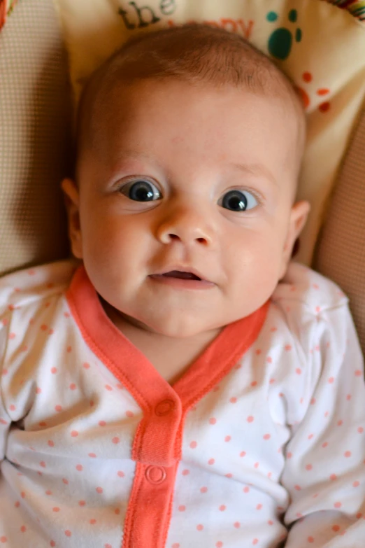 a close up of a baby with eyes wide open