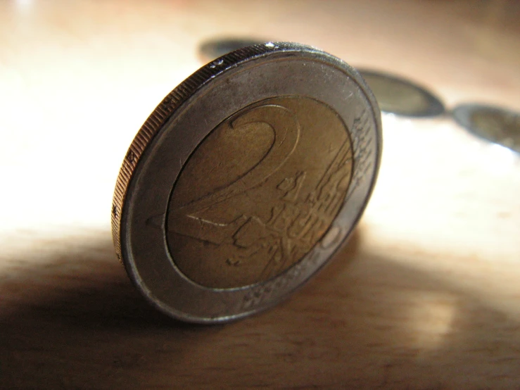 a coin with the u s twenty and twenty dollars below