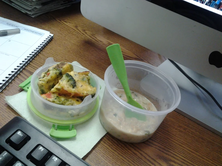 a cup with a spoon and a plate with food