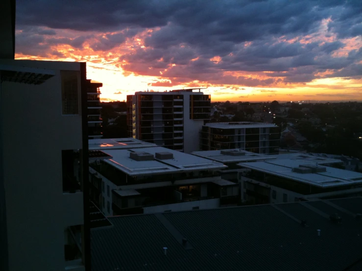 view of building rooftops as the sun sets