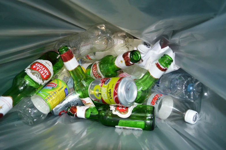 a large amount of plastic bottles inside a trash can