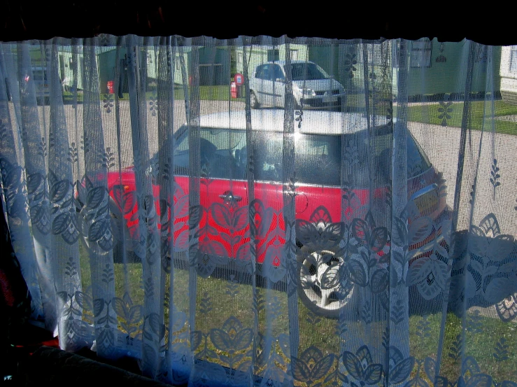 a car is seen through the mesh netting