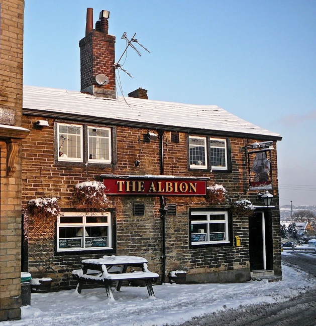 a brick building on the road in winter