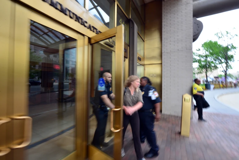 several people are standing outside an office building