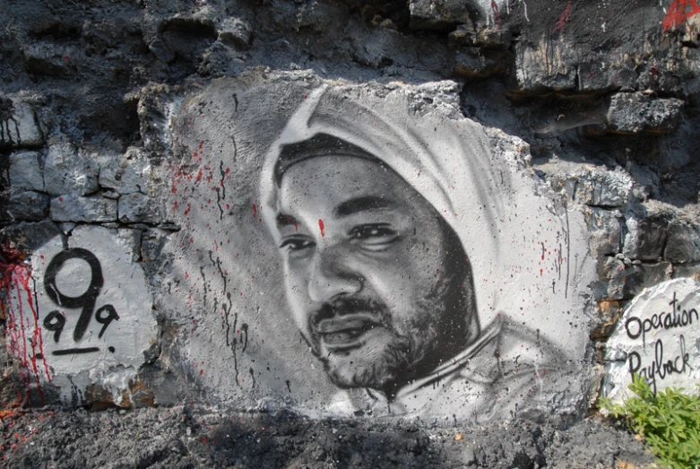 an image of a religious person in black and white on a rock wall