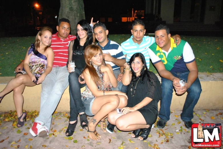 a group of people posing for a po in the evening