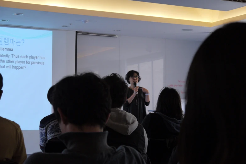 a person in front of a crowd giving a presentation